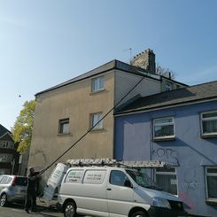 Gutter cleaning at Cardiff using vacuum and poles.