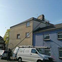 Gutter cleaning at Cardiff using vacuum and poles.